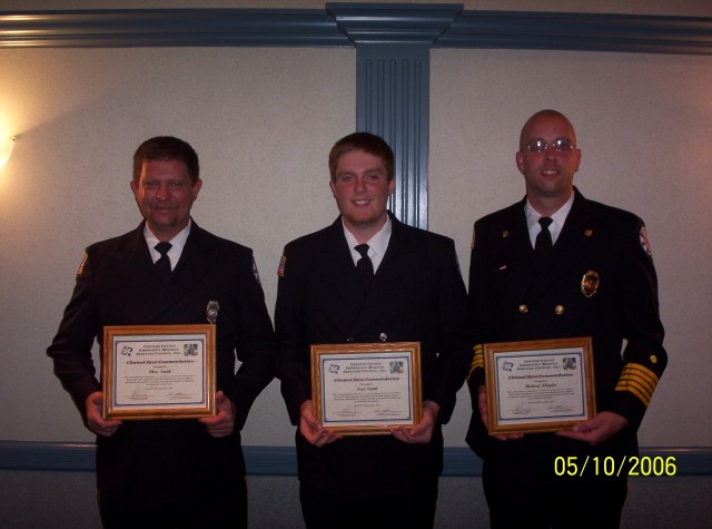 Firefighter Chris Smith, Juinor Firefighter Ford Smith and Fire Chief Richard Klingler receive a clinical life saving award from the county for saving a cardiac arrest victim.